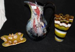 A Murano style multi-coloured jug, together with a yellow,