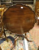 A 19th Century mahogany tilt top tea table with pie crust rim to three cabriole legs