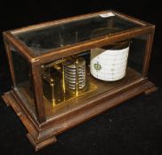 An oak cased and glazed barograph bearing ivorine plaque inscribed "F Smith & Son Southampton"