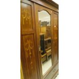 An Edwardian mahogany and inlaid single door wardrobe with swag decoration,
