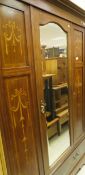 An Edwardian mahogany and inlaid single door wardrobe with swag decoration,