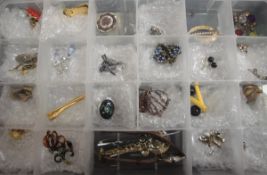 A collection of costume jewellery to include assorted brooches, earrings, wristwatch,