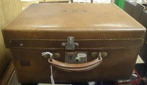 A leather vanity case opening to reveal a fitted interior of moire silk and silver topped dressing