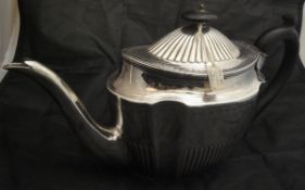 A George III silver teapot with gadrooned and bright cut floral decoration,