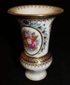 A Sèvres style vase with floral spray decoration within panels of bleu royale, gilt highlighted,