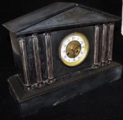 A Victorian black slate cased mantle clock of architectural form with eight day movement and Arabic