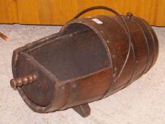 A coopered wooden barrel cut down as a coal bucket