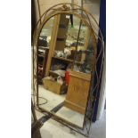 An arched top wall mirror in painted iron frame