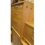 A suite of modern bedroom furniture in beech effect finish to include a chest of four long drawers,