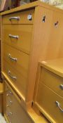 A suite of modern bedroom furniture in beech effect finish to include a chest of four long drawers,