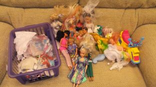 A basket containing various Barbie and other dolls, an LFC Rubik's Cube Collector's Edition,