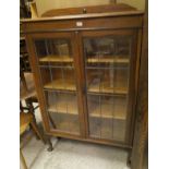 An oak display cabinet with leaded glazed doors on cabriole legs