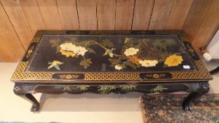 A 20th Century Chinese rectangular coffee table on a black ground decorated with song birds amongst