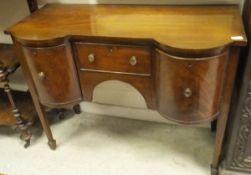 A mahogany dressing table with single drawer flanked by cupboard doors on square section tapering