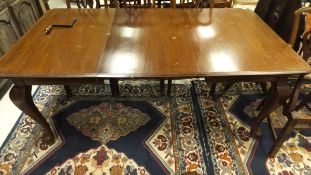 A late 19th Century mahogany rectangular dining table on cabriole legs