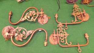 Two pairs of brass single branch wall light fittings,