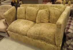 A Knoll style sofa with yellow upholstery with green treen decoration