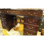 A mahogany pedestal desk of nine drawers