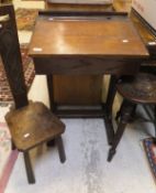 An oak child's desk, an oak stool with carved seat on three turned stretchers,