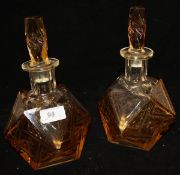 A pair of early 20th Century Art Deco style decanters with cut and amber flash decoration