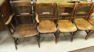 A set of four Oxford bar back elm seated chairs to include one carver,