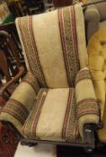 A Victorian mahogany framed armchair in striped and patterned upholstery on turned legs to brass