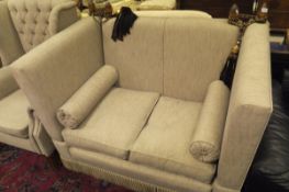A knoll type two seat sofa and wingback armchair in oatmeal upholstery