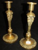 A pair of brass table candlesticks in the Empire taste,