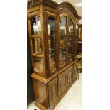 A 20th Century display cabinet with four glazed doors enclosing two glazed shelves on a base of