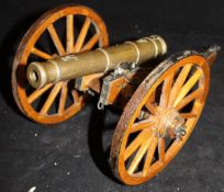 A 20th Century bronze model of a 19th Century cannon baring crowned L sypher on a wooden carriage