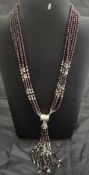 A silver and garnet multi-strand beaded necklace