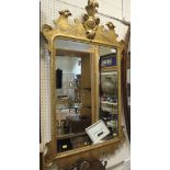 A rectangular bevel edged gilt framed wall mirror in the Rococo taste CONDITION REPORTS