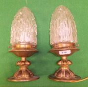 A pair of brass ceiling light fittings with stepped cut glass shades