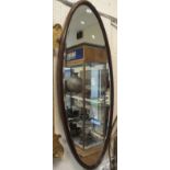 A mahogany framed oval wall mirror