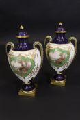 A pair of Royal Worcester two handled vases decorated with panels of cattle by water's edge by