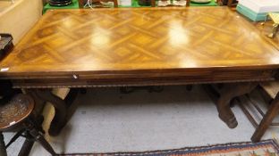 A French draw leaf dining table on four legs terminating to paw feet