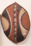 An African leather painted shield of oval form