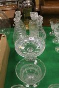 A set of three Georgian cut glass decanters, together with a further modern decanter,