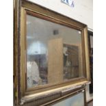 A rectangular wall mirror in a gilt frame