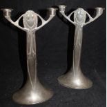 A pair of pewter twin branched candelabra in the Art Nouveau taste on a single column to oval base