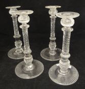 A set of four near matching 18th or early 19th Century cut glass candlesticks with wrythen cut and