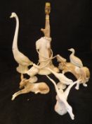 A collection of five various Lladro figures including Bassett hound, donkey, two geese and a swan,