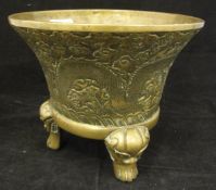 A Chinese bronze censer of inverted bell form decorated with dragons amongst clouds with peaches,