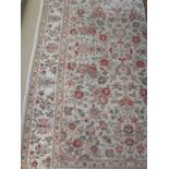 A Persian rug, the central panel set with all-over floral sprays on a cream ground,