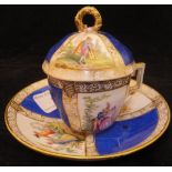 A Meissen miniature chocolate cup and saucer with figural design and simulated breakages within the