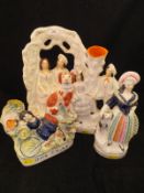 A collection of four 19th Century Staffordshire figure groups including "Dog tray" depicting girl