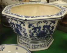 A Chinese blue and white octagonal jardinier with scrolling foliate decoration on a pierced