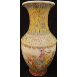 A Chinese famille-rose vase decorated with various figures in procession within bands of scrolling