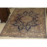 A Chinese carpet, the central floral decorated medallion in cream, green,