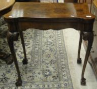 A walnut and mahogany cross-banded card table, the lift top revealing a green baize,